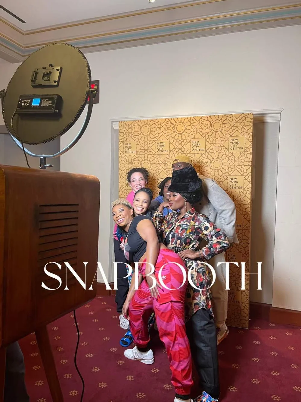 Guests posing in a vintage photo booth at a New York City event