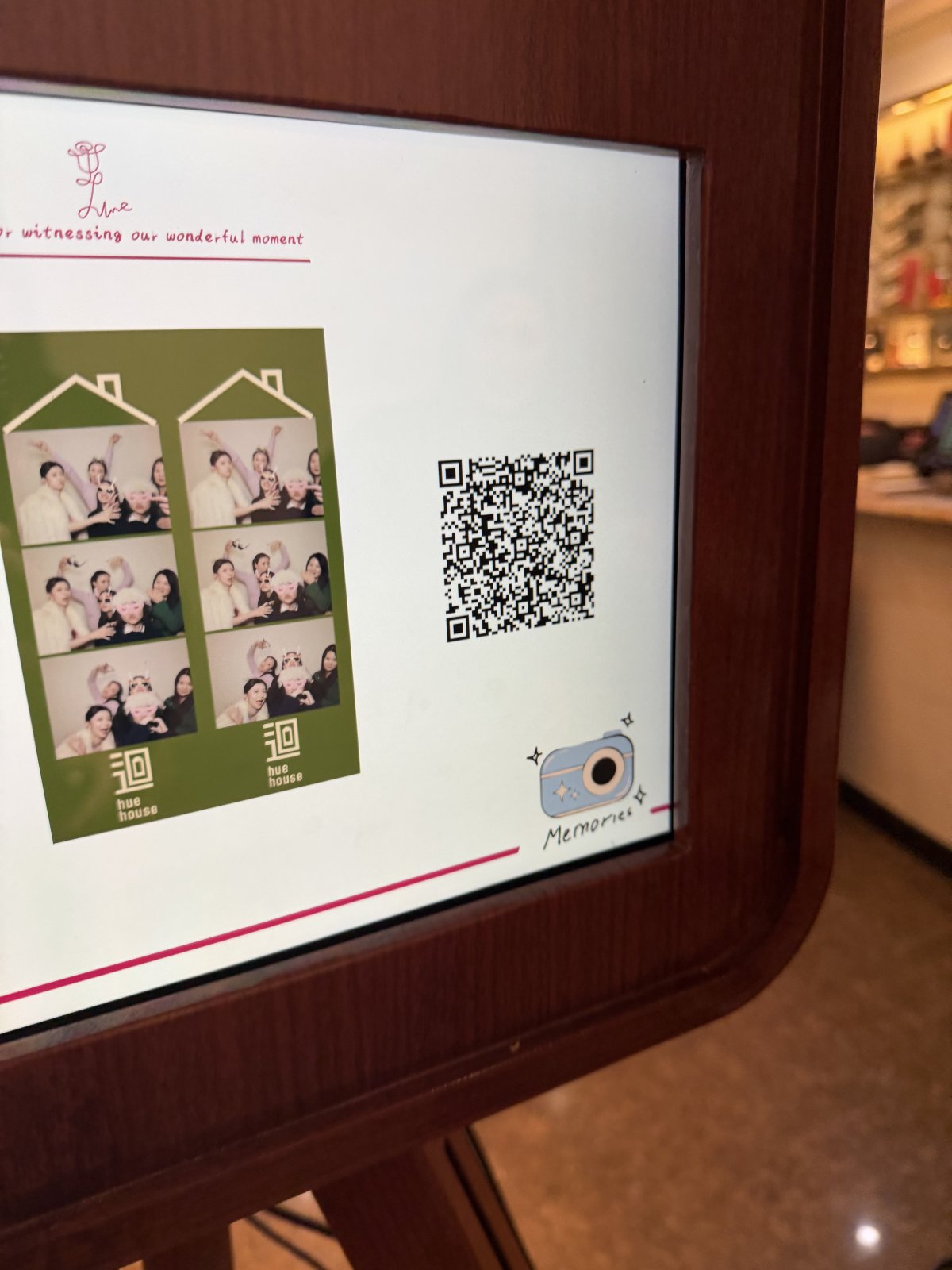 Snapbooth screen displaying green photo strips and a QR code for instant downloads